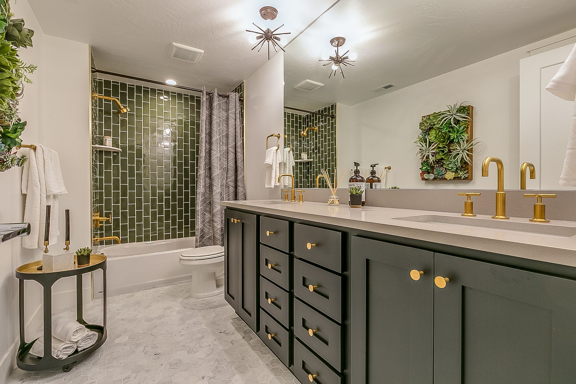 A bathroom with two sinks , a tub and a mirror.
