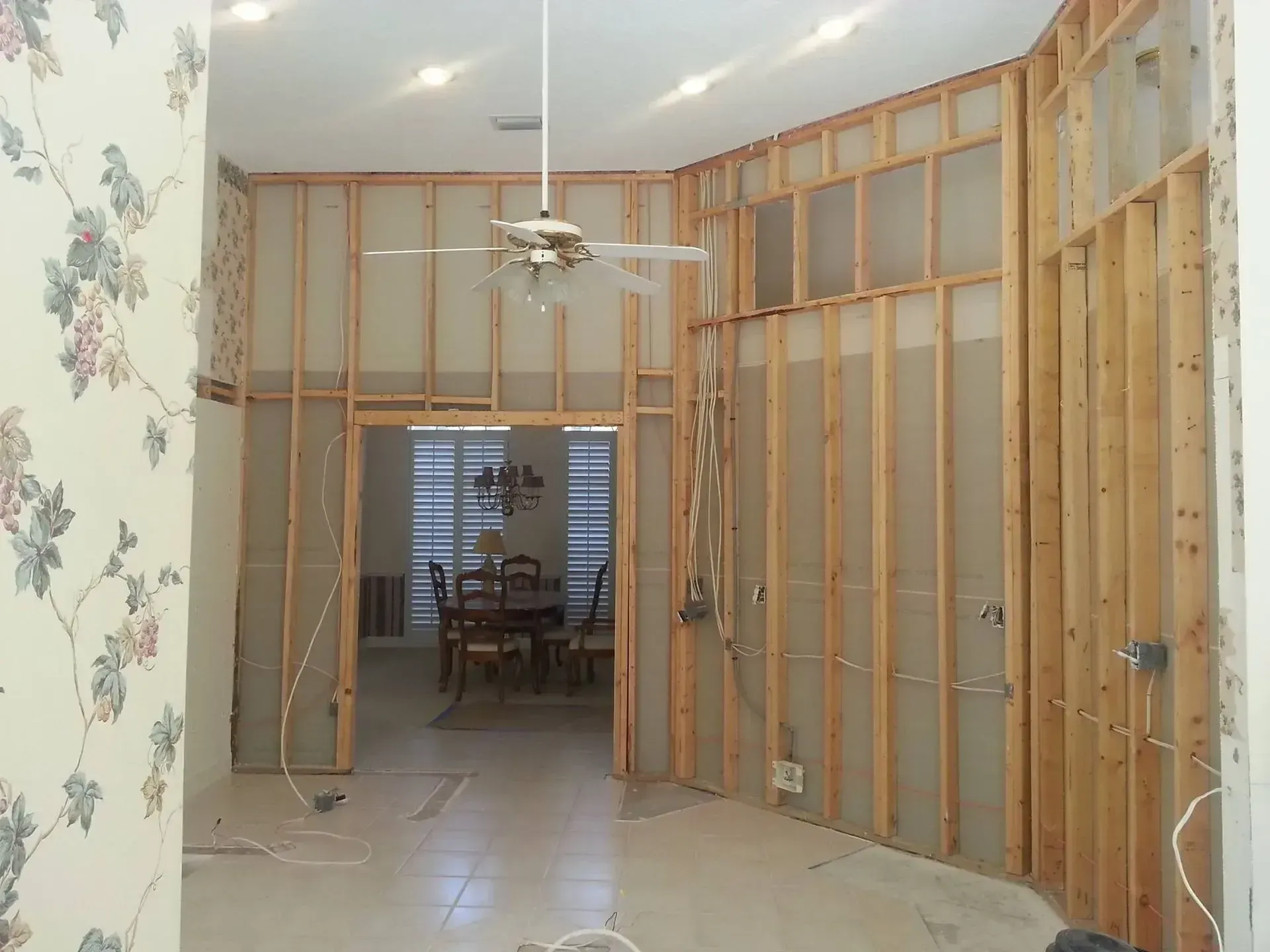 A room with a lot of windows and a broom on the floor