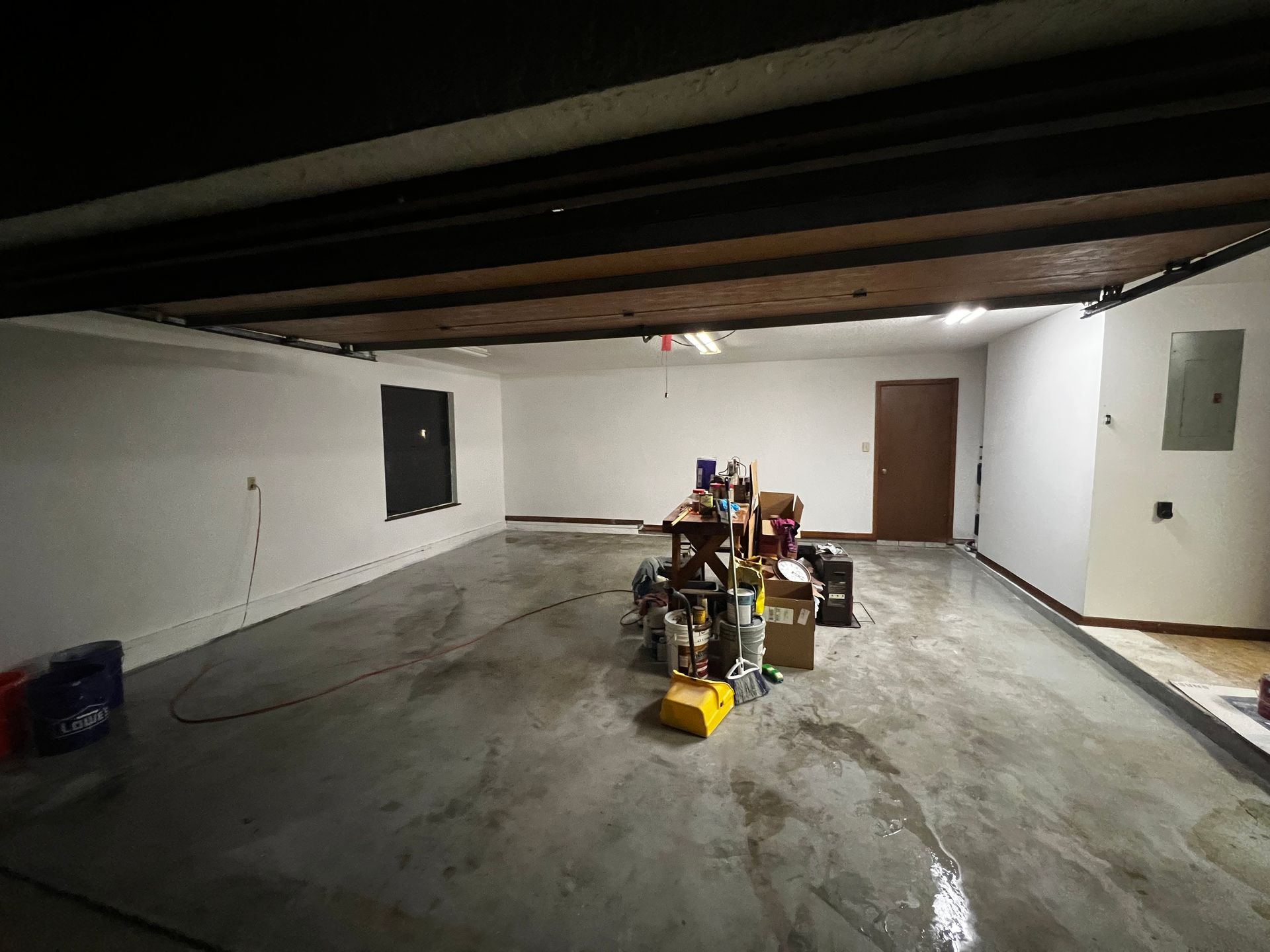 A large empty garage with a lot of boxes on the floor.