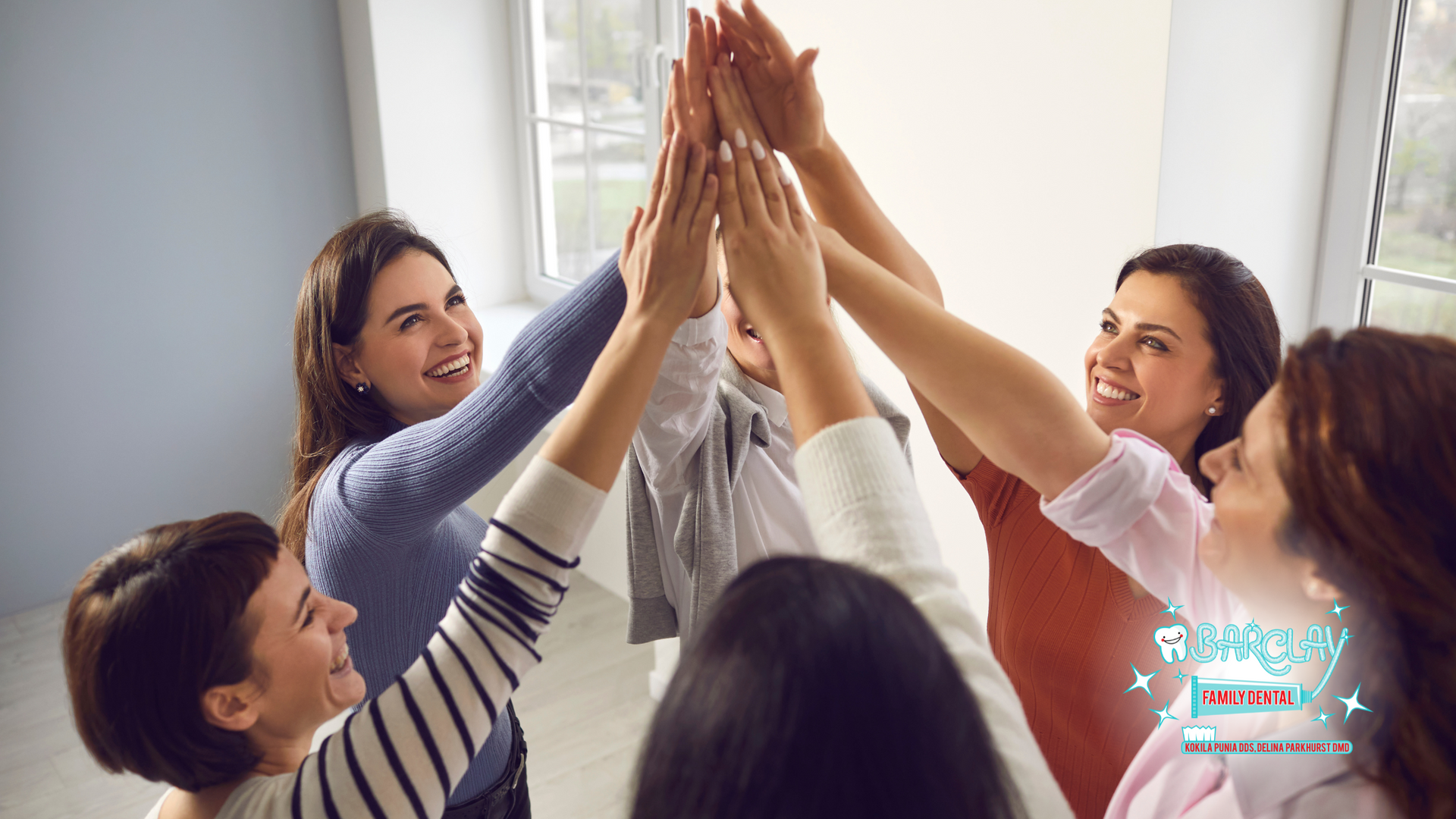 A group of women are giving each other a high five.