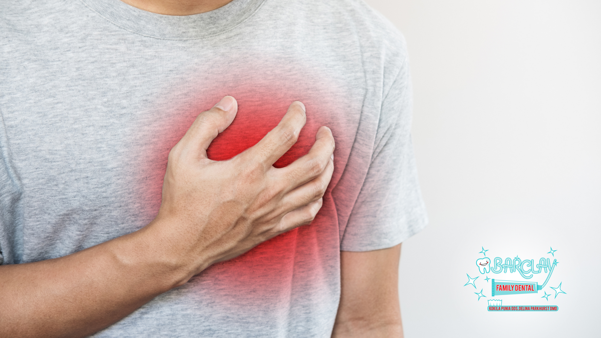 A man is holding his chest in pain because he has a heart attack.