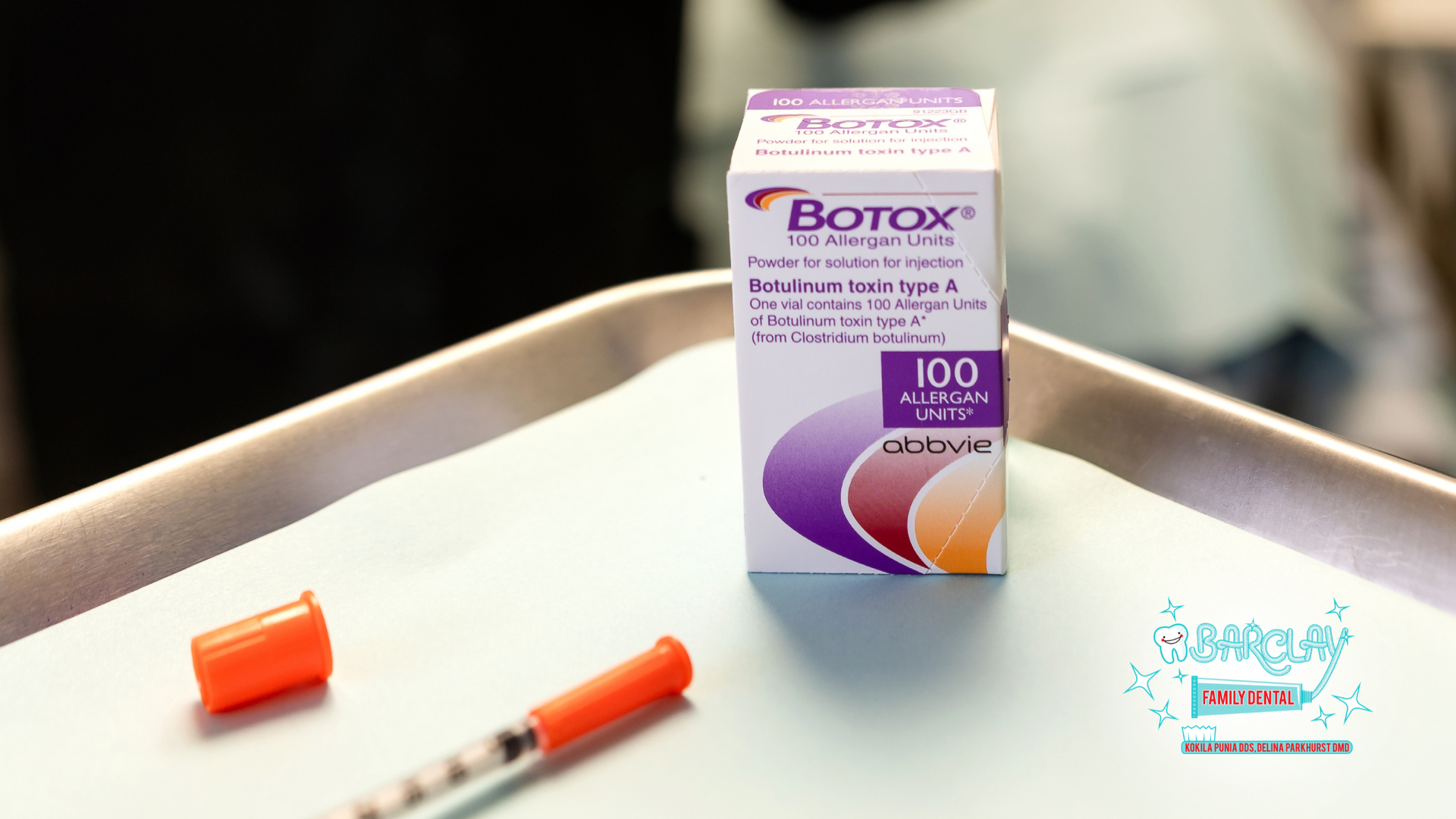 Botox box and syringe on a table with a purple cap beside them