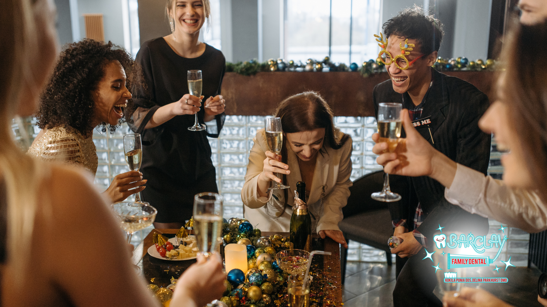 A group of people are sitting around a table drinking champagne.