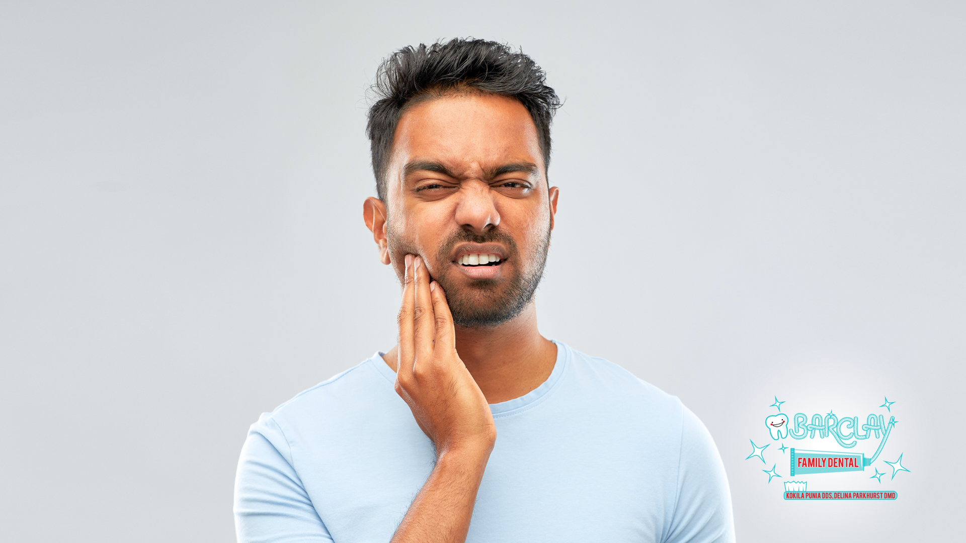 A man is holding his face in pain because of a toothache.
