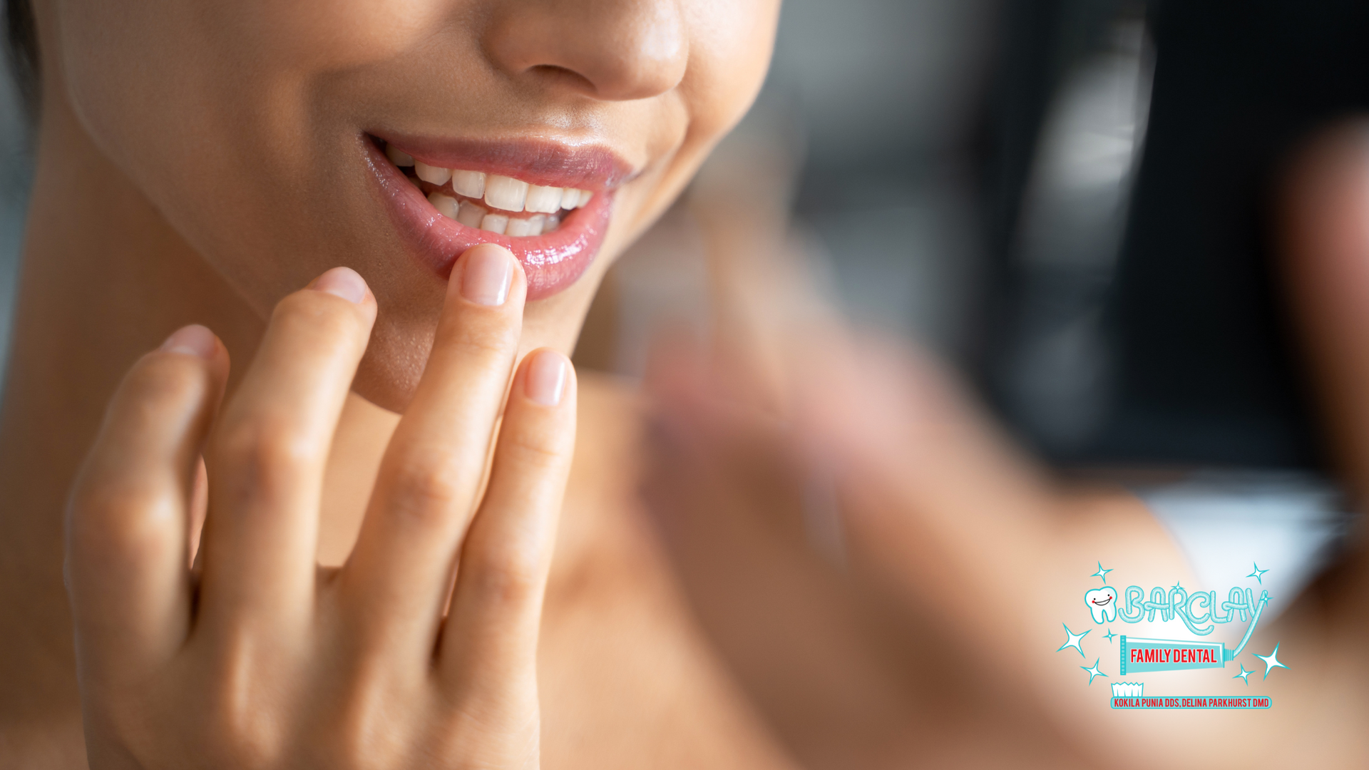A woman is touching her lips in front of a mirror.