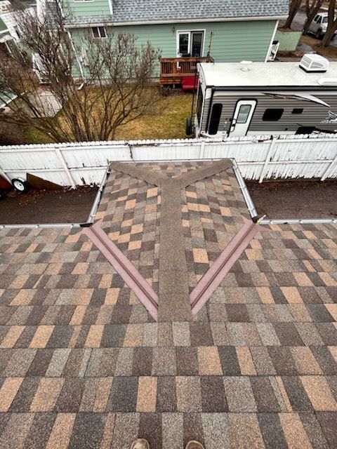 An aerial view of a house with a roof and a window.