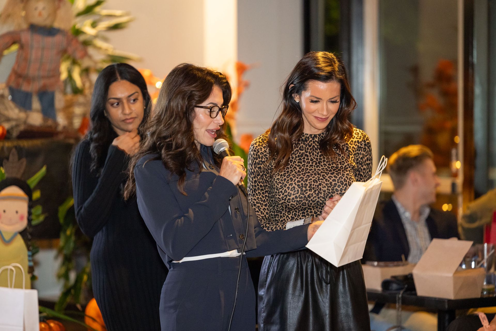 A group of women are standing next to each other holding microphones.