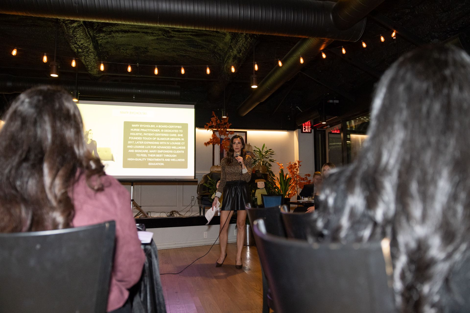 A woman is giving a presentation to a group of people