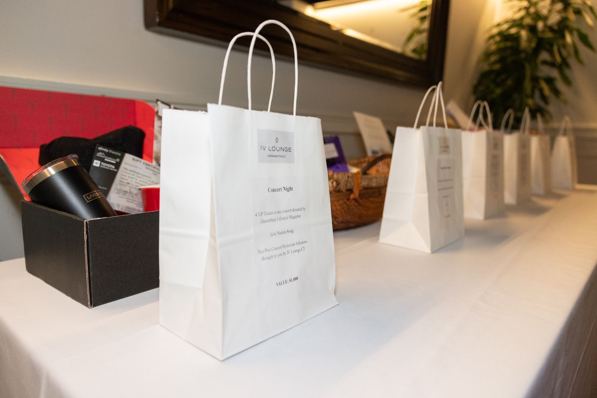 A row of white bags are sitting on a table.