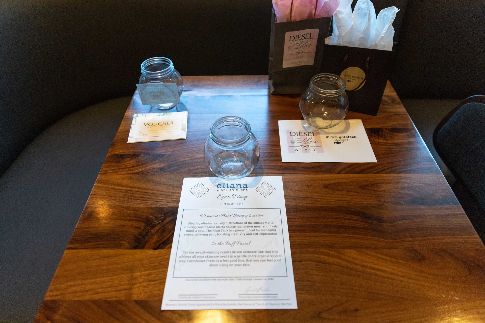 A wooden table with a menu and glasses on it