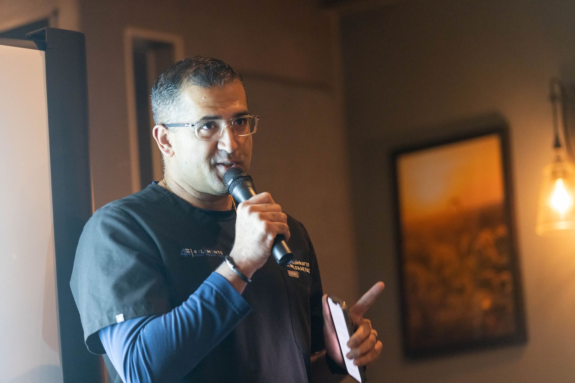 A man is holding a microphone in his hand and talking into it.