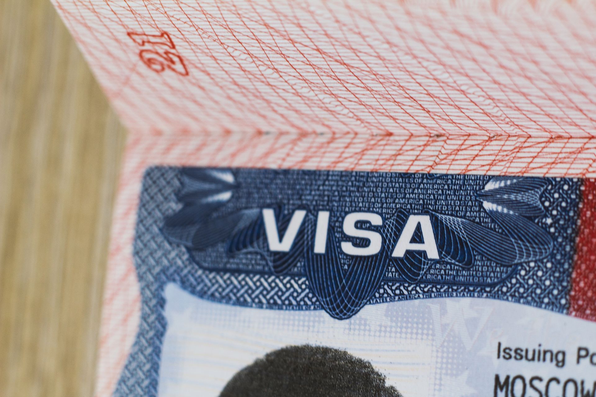 Open passport displaying a VISA stamp, with Moscow as the issuing place.
