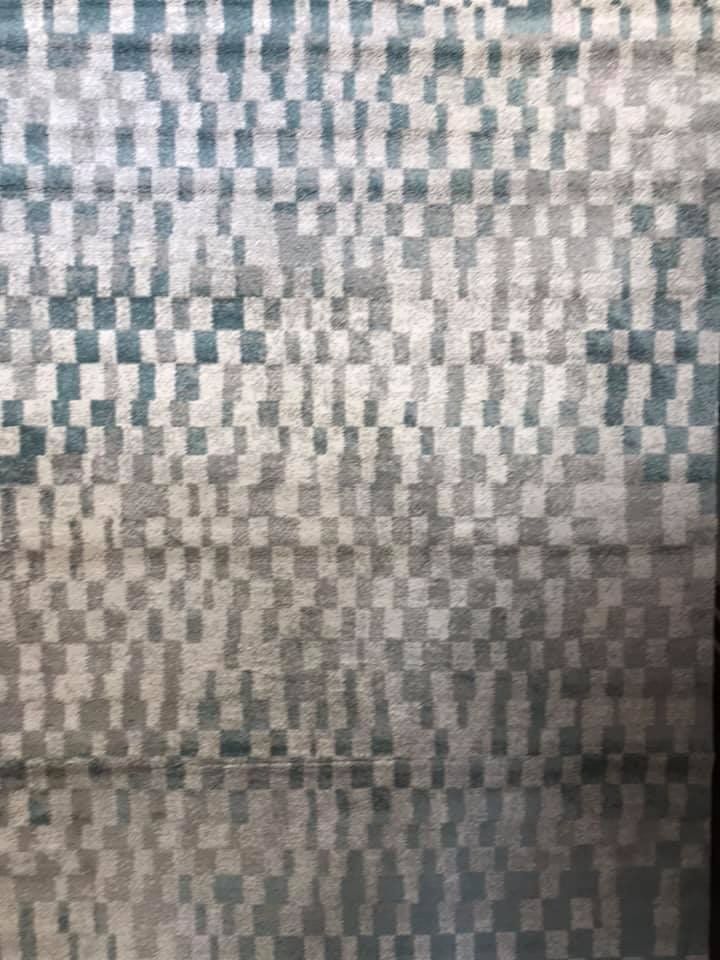 A Close Up Of A Rug With A Checkered Pattern On It — Charmhaven Carpets In Charmhaven, NSW