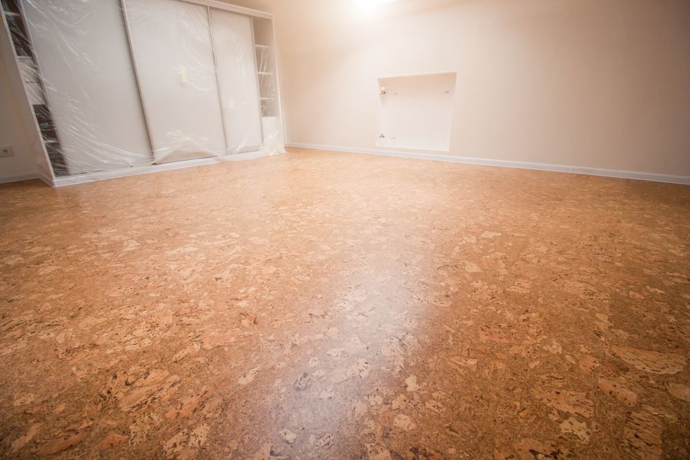 Empty Room With Cork Flooring and Beige Walls — Charmhaven Carpets In Charmhaven, NSW