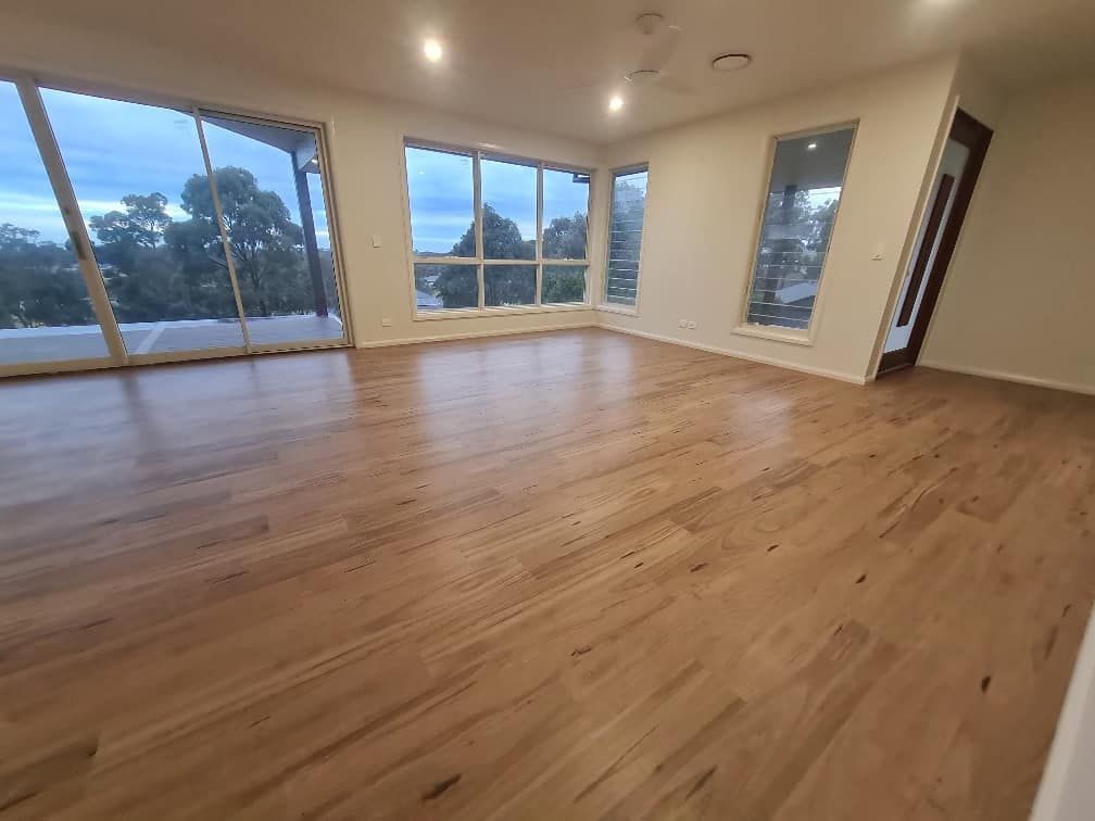 Empty Modern Room with Hardwood Floors — Charmhaven Carpets In Charmhaven, NSW