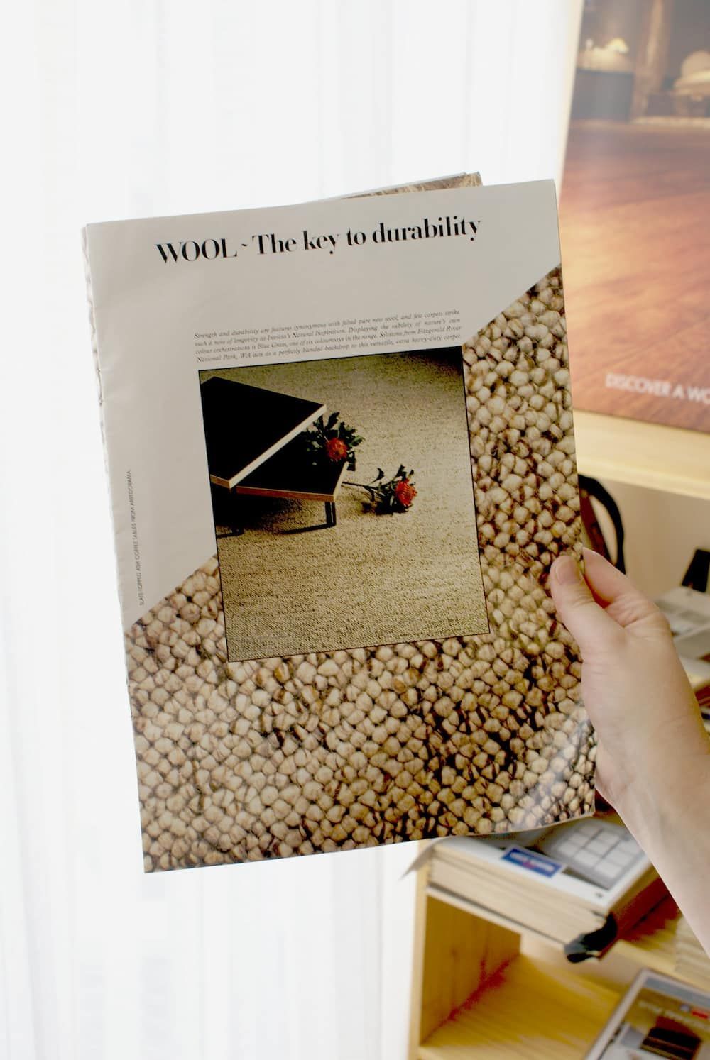 A Person Is Holding A Book That Says Wow On It — Charmhaven Carpets In Charmhaven, NSW