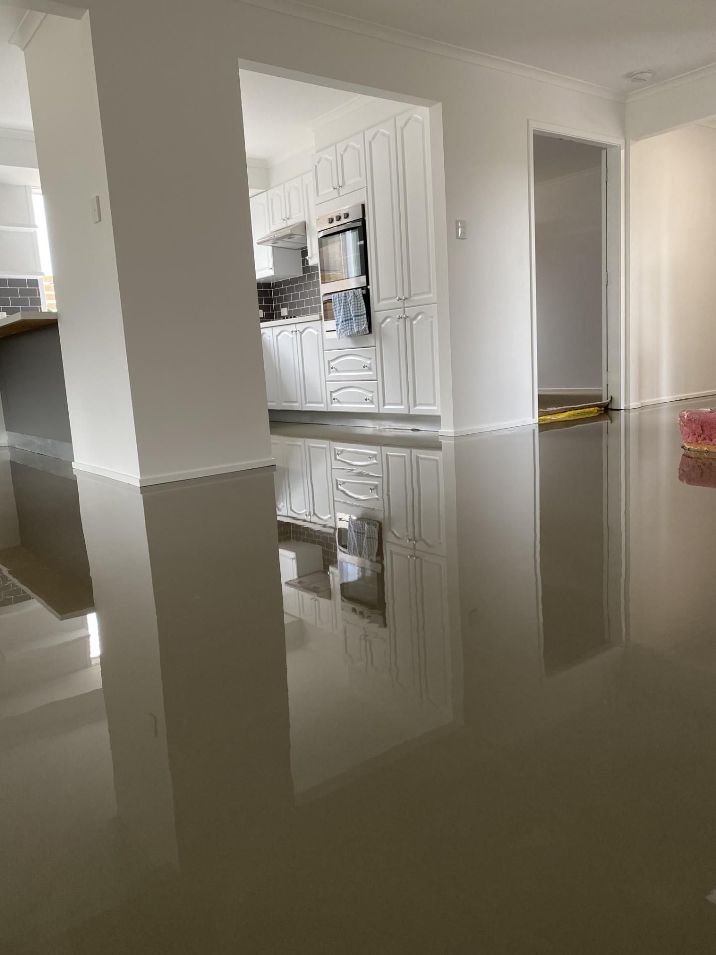A kitchen with polished concrete flooring — Charmhaven Carpets in Newcastle, NSW