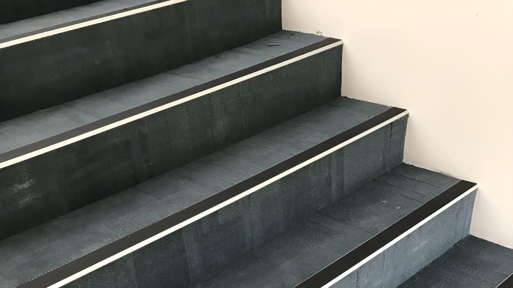 A Close Up of a Set of Stairs With Black Steps and White Trim — Charmhaven Carpets in Hunter Valley, NSW