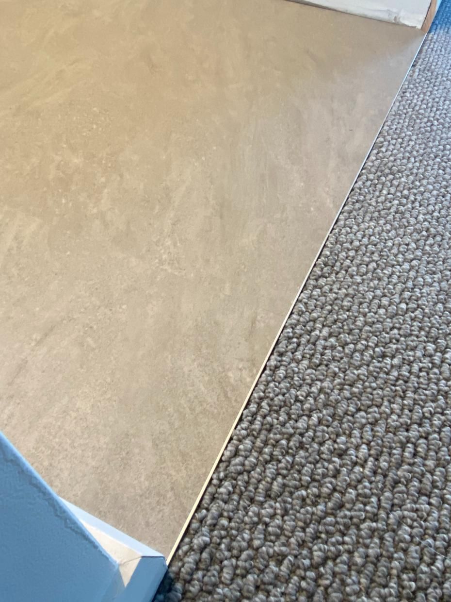 A Close Up Of A Wooden Floor In A Room With A Window — Charmhaven Carpets In Charmhaven, NSW