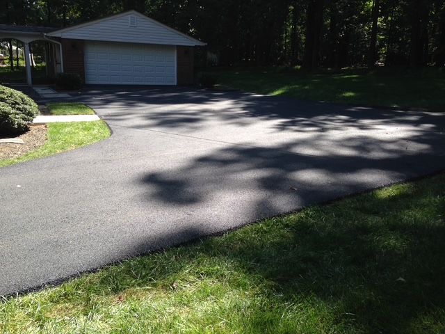 A driveway leading to a garage and a house