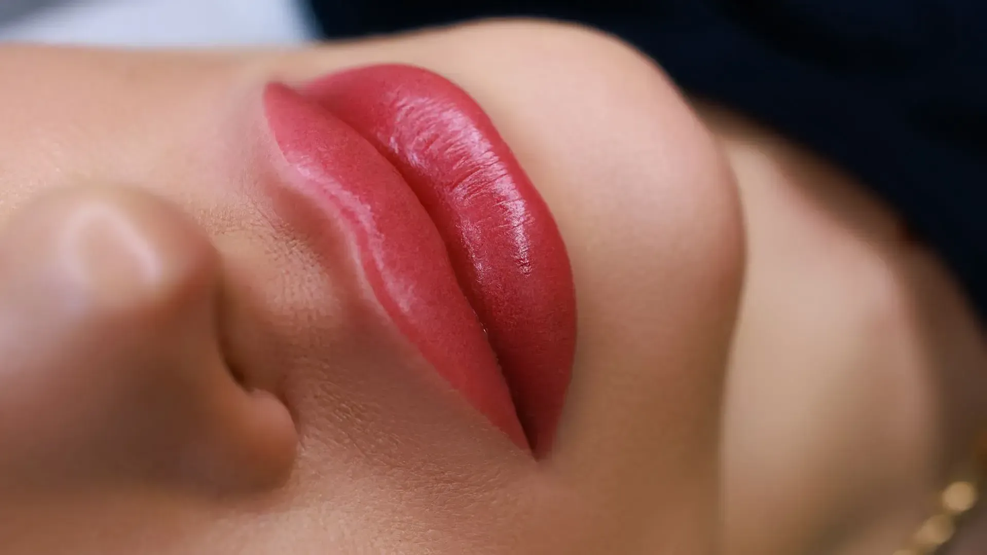 A close up of a woman 's lips with red lipstick.