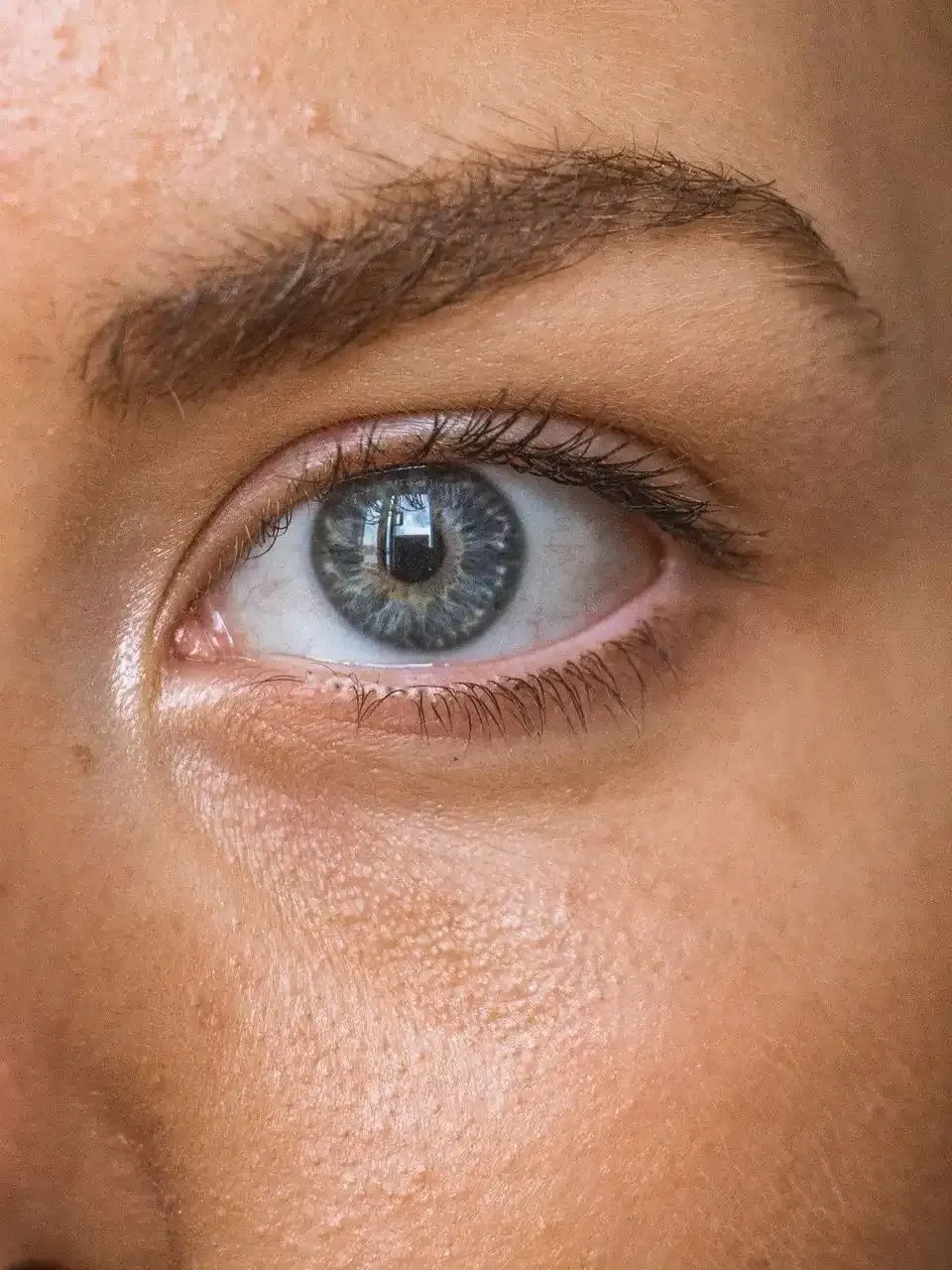 a close up of a woman 's blue eye