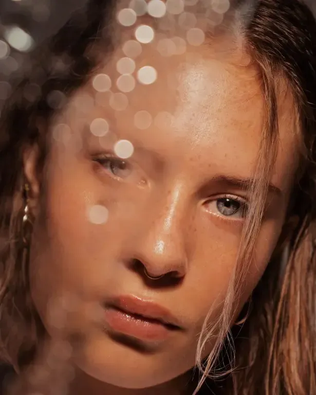 a close up of a woman 's face with a blurry background