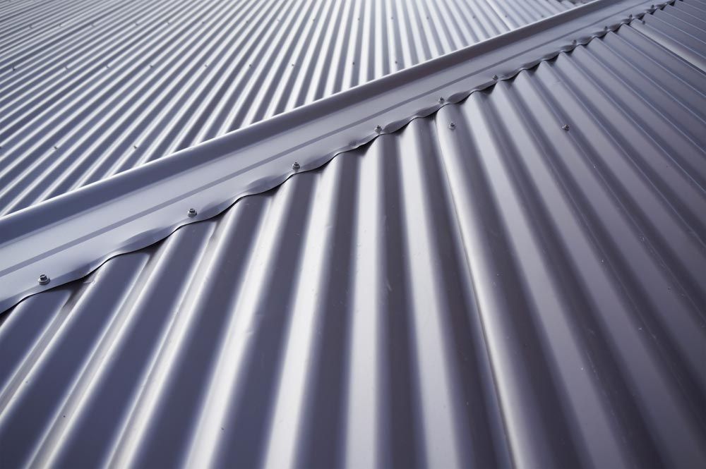 A close up of a metal roof with a diagonal pattern