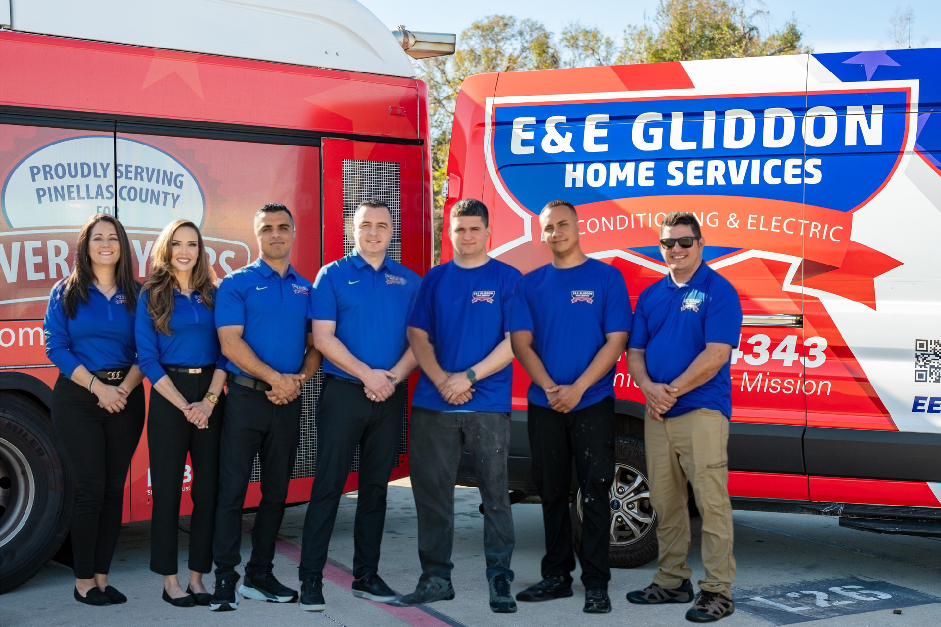 Two women in blue shirts standing in front of an E&E Gliddon Home Services company van
