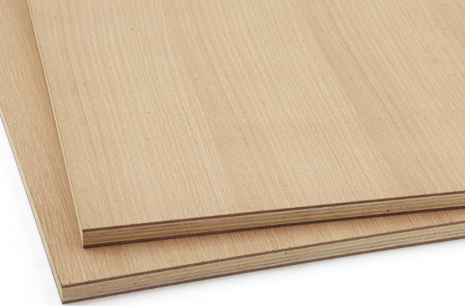 Two light-colored wood panels, stacked, showing the grain on the surface and the edge of the boards.
