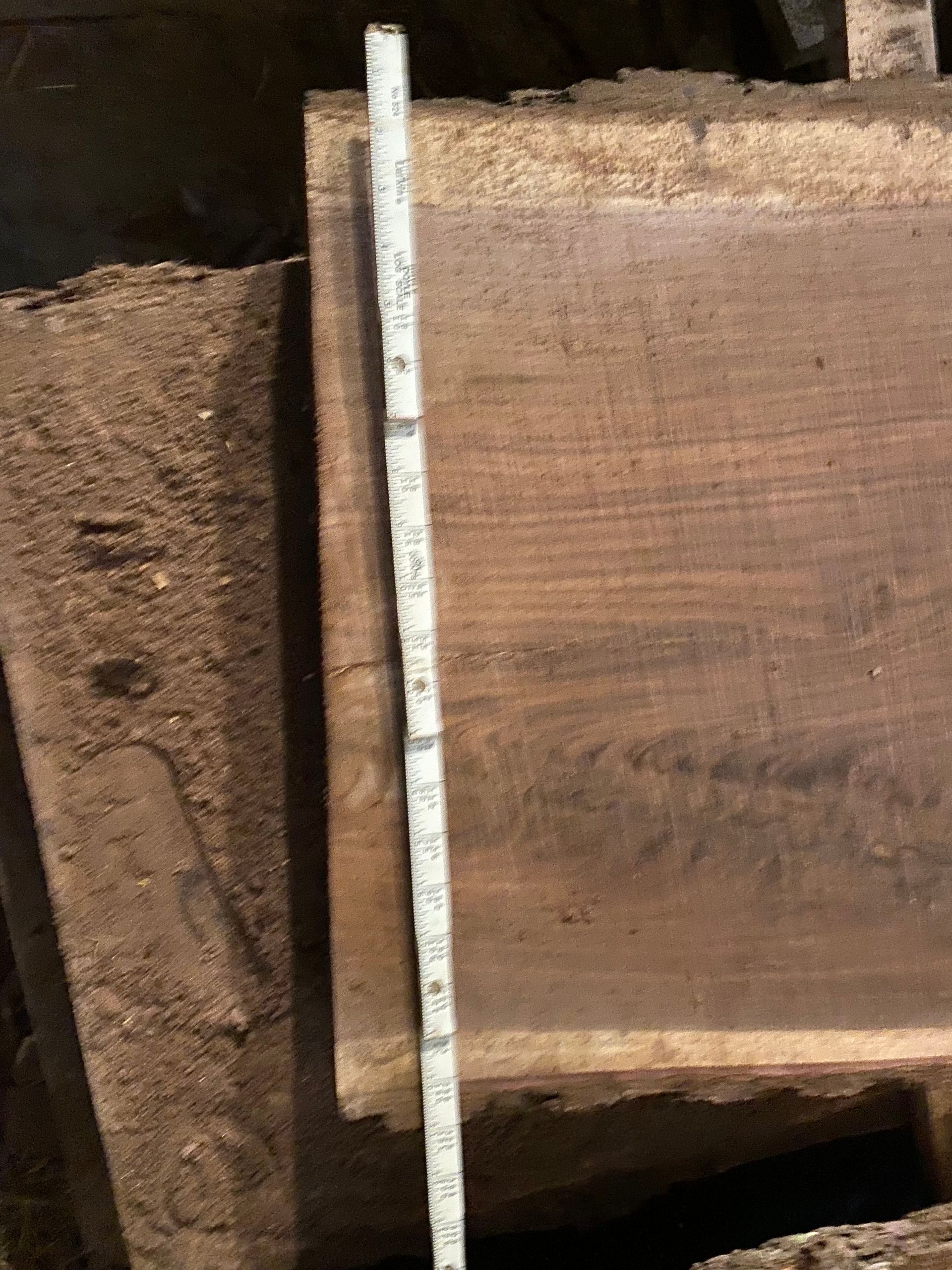 Wooden planks with a measuring tape laid across them.