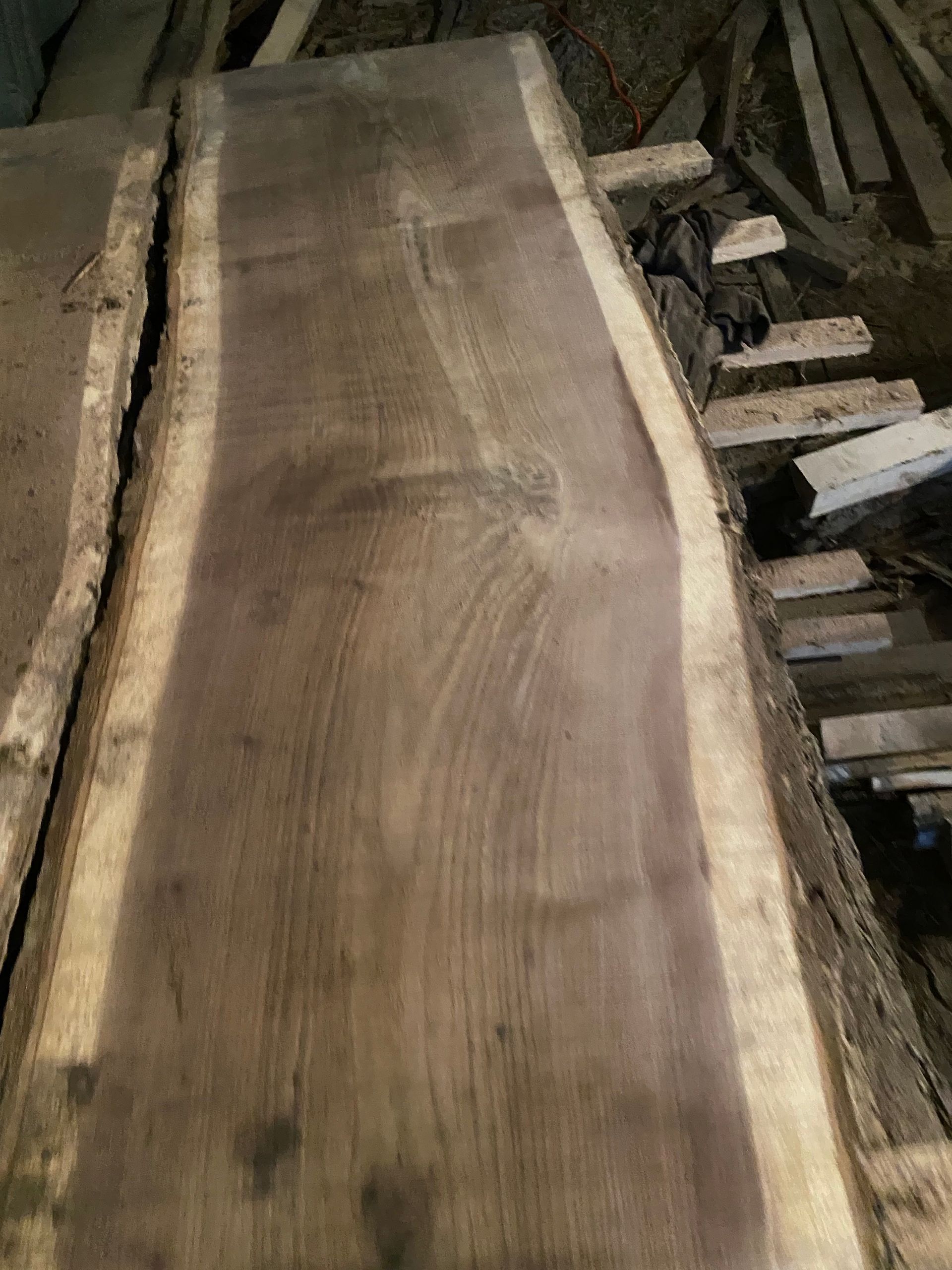 Dark wooden slab with natural edge.