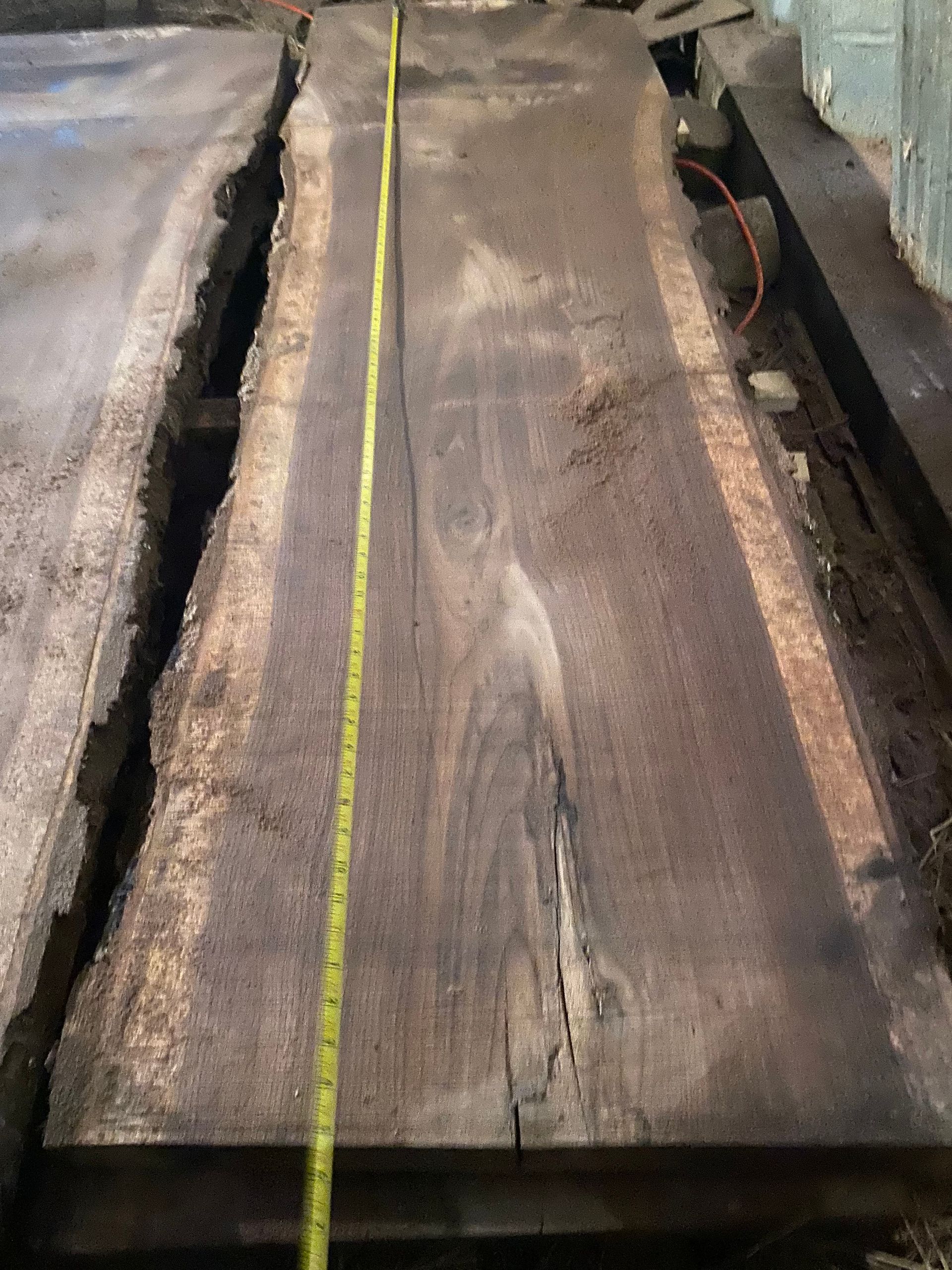 Wooden plank with a measuring tape laid across it.