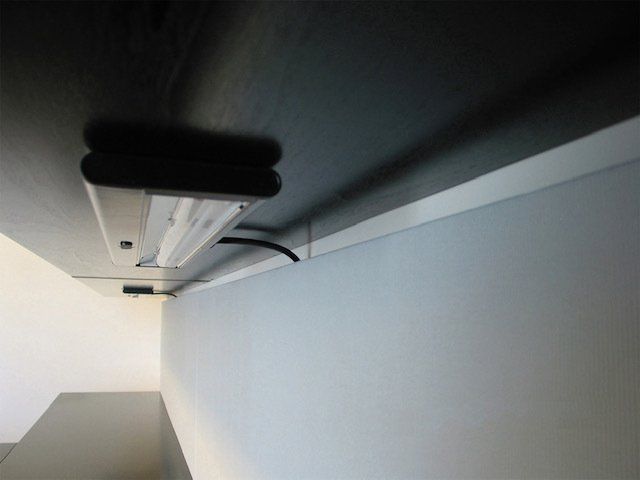 A light fixture is hanging from the ceiling in a room