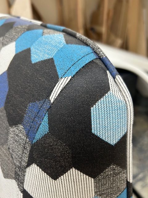 A close up of a couch with a blue and black pattern