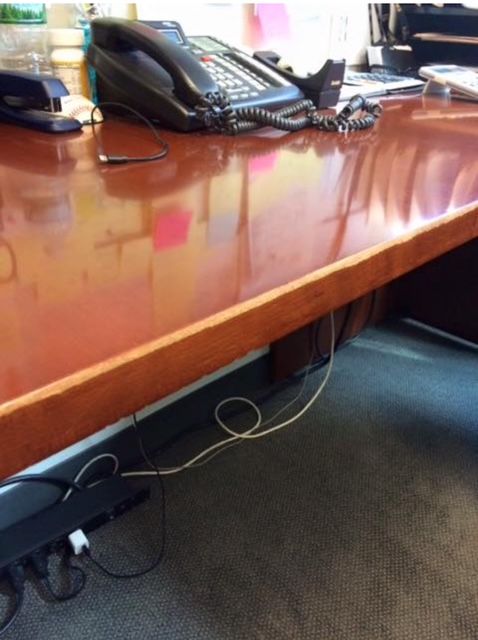A black leather chair with a broken arm rest