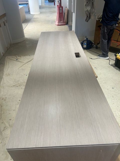 A wooden table is sitting on a wooden floor in a room.