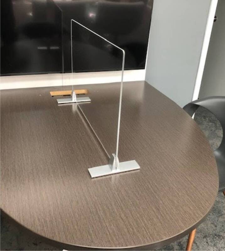 A table with a clear acrylic divider on it
