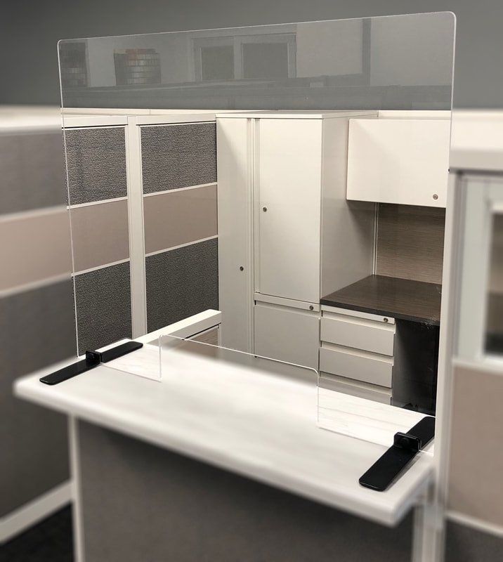 A counter with a clear acrylic divider on top of it