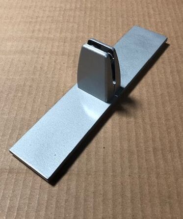 A metal object is sitting on top of a cardboard box.