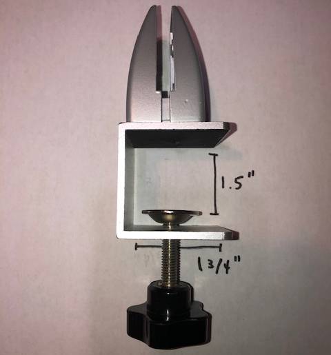 A metal clamp with measurements written on it