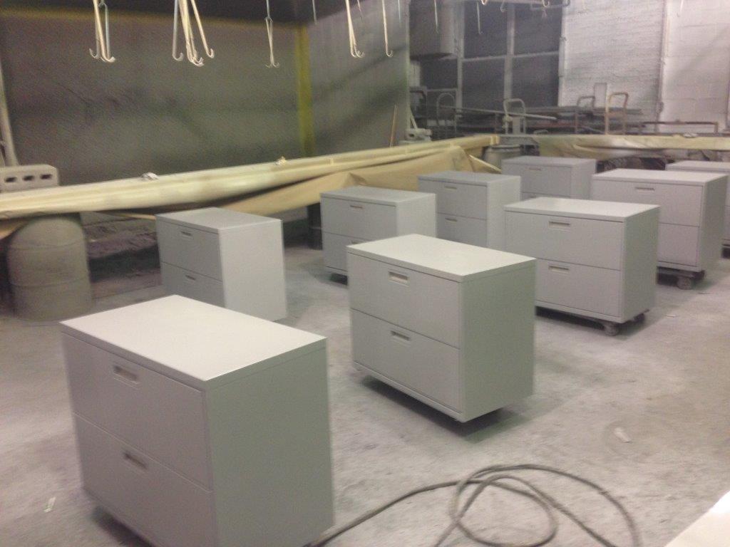 A row of white cabinets on wheels in a room