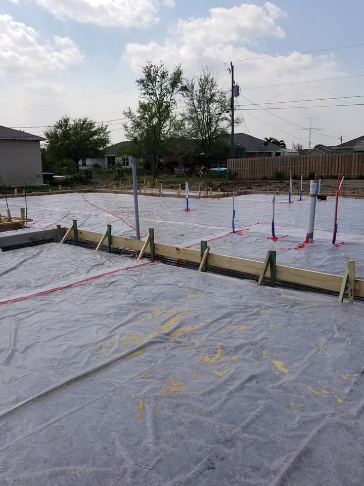 A concrete foundation is being built in a residential area.