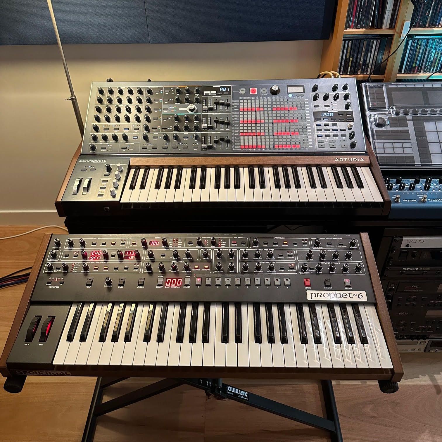 three keyboards are sitting on top of each other on a table .