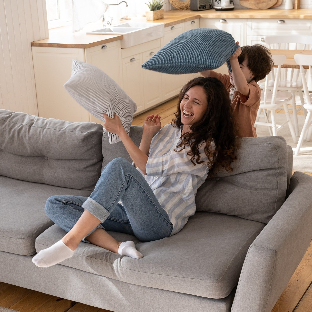 Happy playful mom in newly bought house