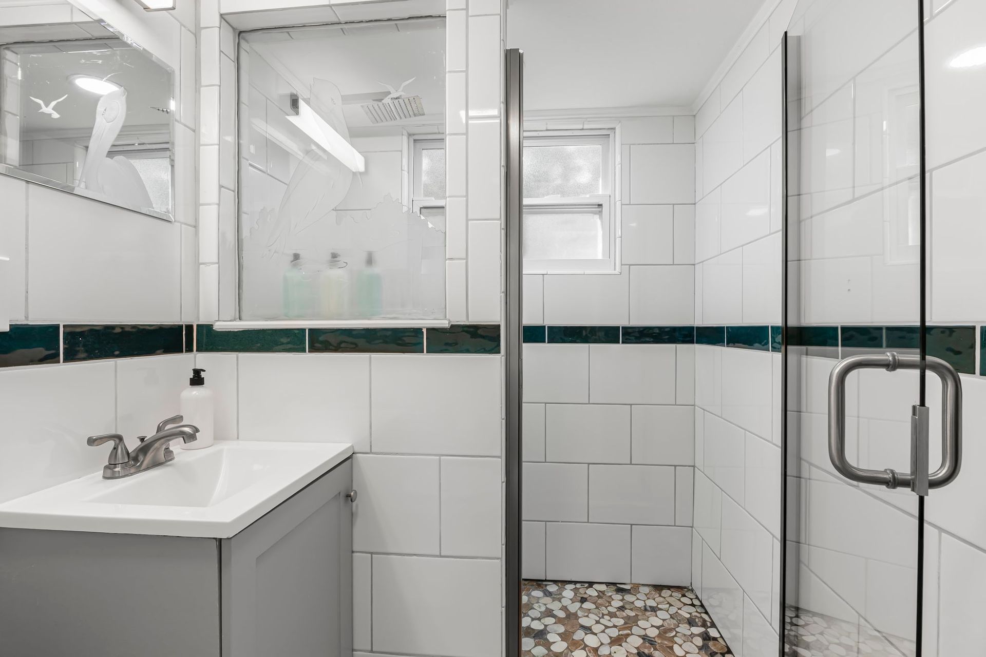 A bathroom with a toilet , sink , and shower.