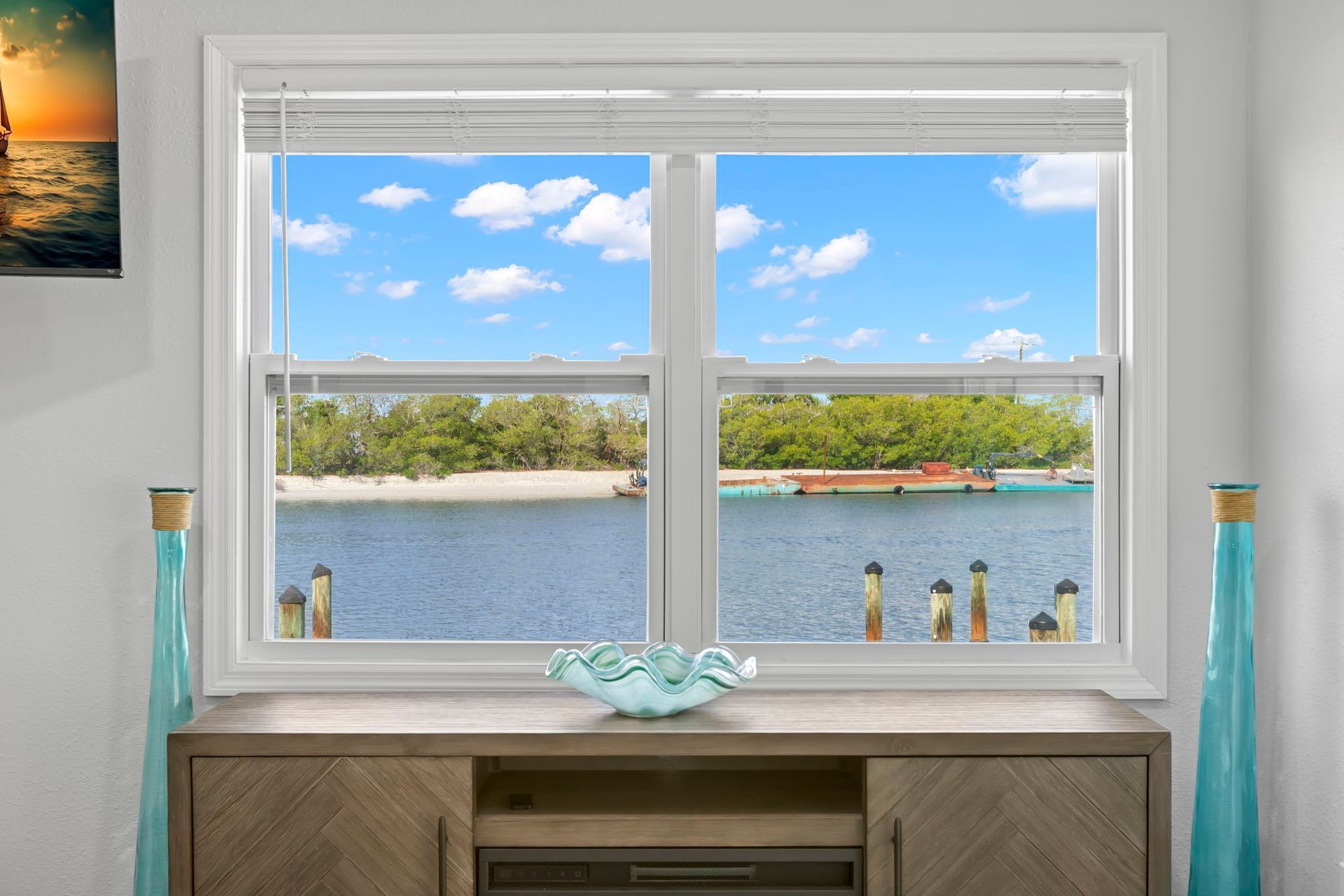 A laundry room with a washer and dryer and a window.