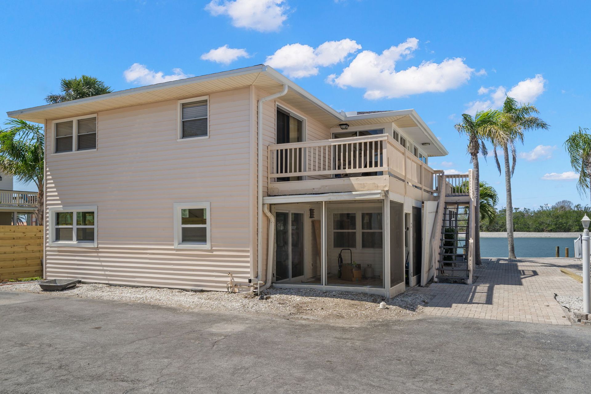 A large house with a lot of windows and a balcony overlooking a body of water.