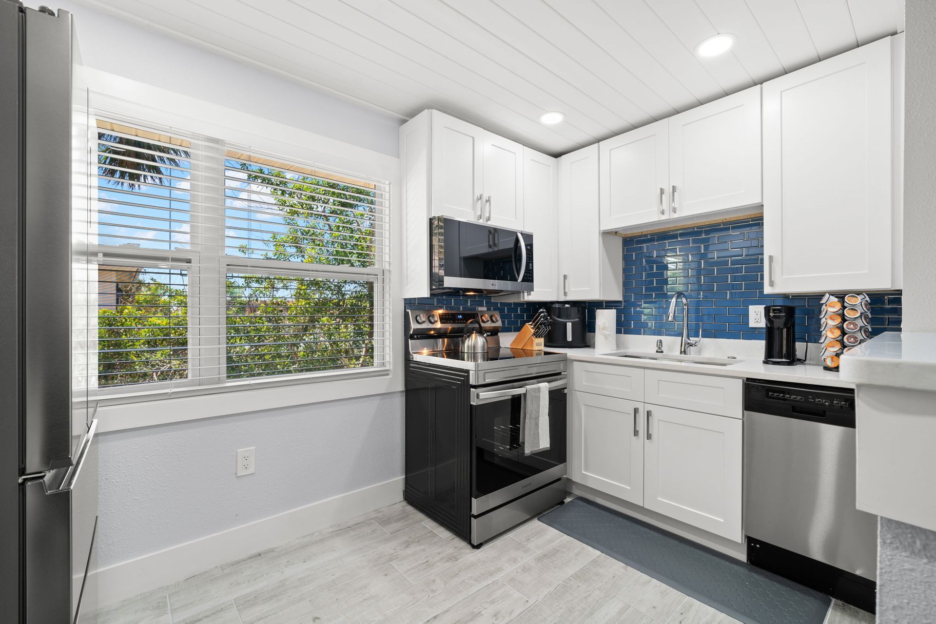A kitchen with white cabinets and stainless steel appliances.