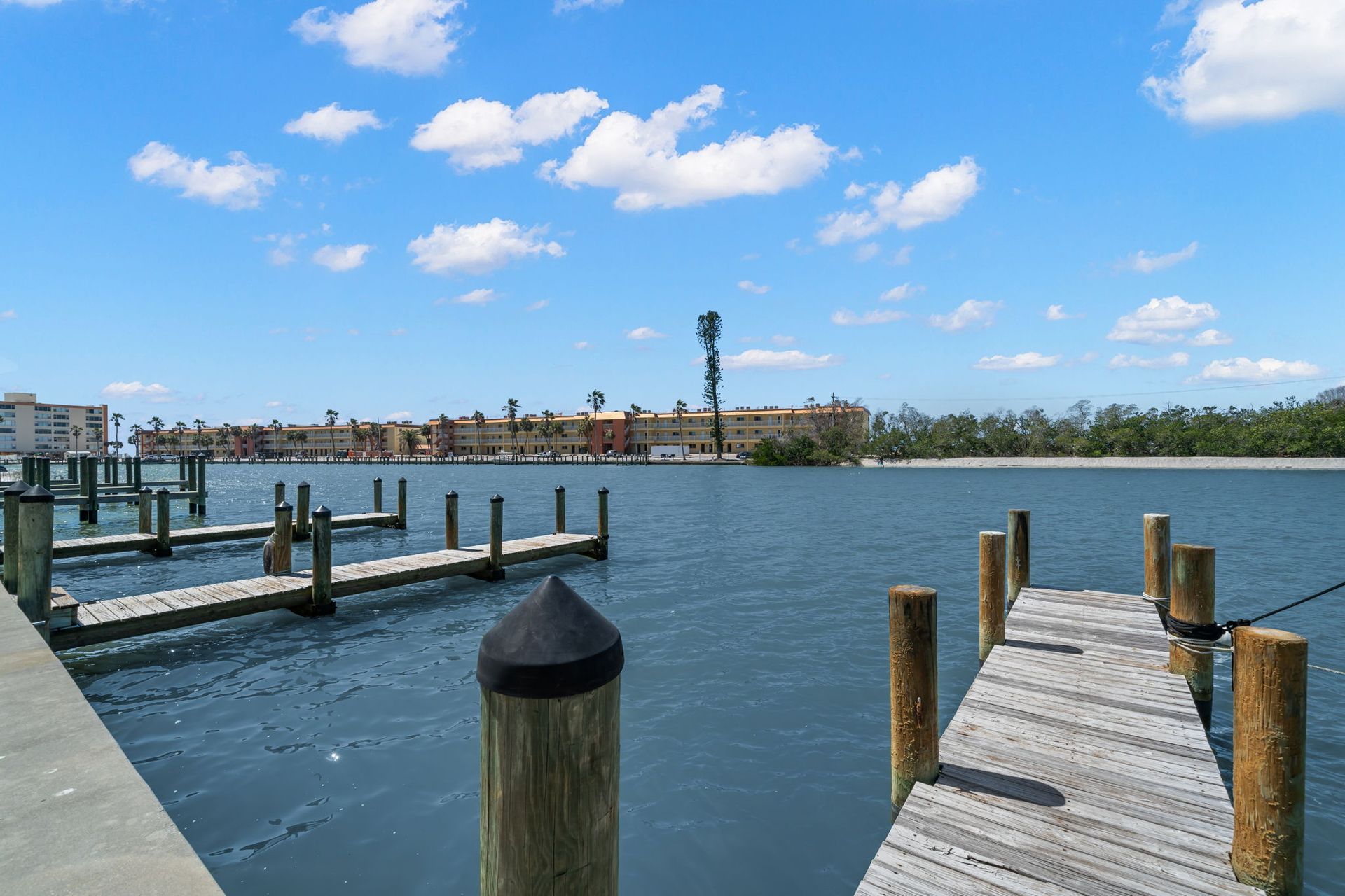 A dock overlooking a body of water with a lighthouse in the background.